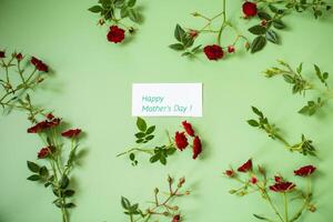 Arrangement of small red roses isolated on green photo