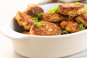 Homemade cutlets with a golden crust on a wooden table . photo