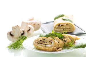 Homemade zucchini roll with mushroom filling on a white background photo