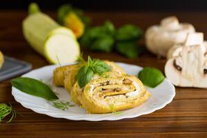 Zucchini roll with baked mushrooms and cheese . photo