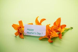 Top view of bright lilies with greeting card photo