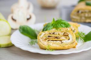 Zucchini roll on a light wooden background photo