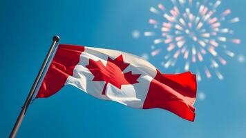 A vibrant flag waves against a clear blue sky with celebratory fireworks in the background. photo