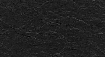 A black stone texture with a rough surface photo