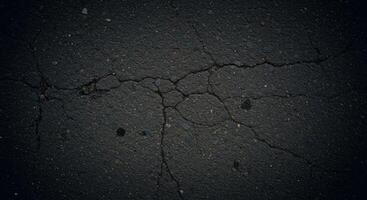 Cracked asphalt background with cracks and cracks photo