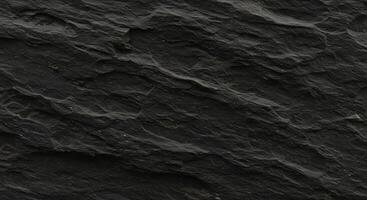 A black rock texture with some small cracks photo