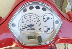 Speedometer on a red scooter close-up photo