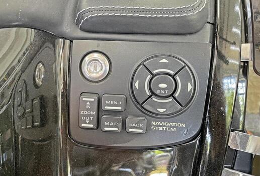 Close-up of Motorcycle Navigation System Control Panel with Zoom, Map, and Menu Buttons photo