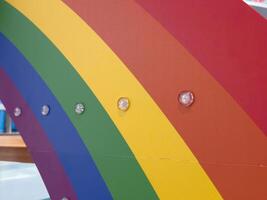 Colorful rainbow arc with embedded lights on display at a theme park photo