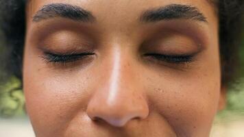 Cropped view close up female dark close eyes closed vision eyesight laser correction African American happy woman smiling healthy health medicine girl lady face dreaming wish in city urban outdoors photo