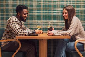 Young couple using a smartphone while eating at a restaurant, capturing memories and sharing joy during a romantic evening. photo