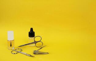 Manicure accessories on yellow background for business photo