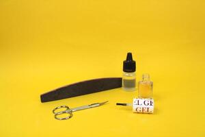 On a yellow background there are items for manicure, open nail polish photo