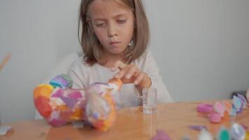 Cute Caucasian girl doing creative homework project with colorful paints video