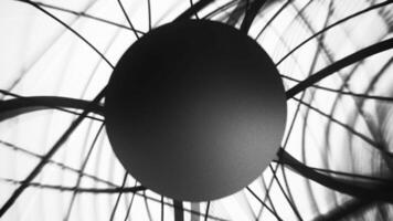 Black sphere rotating behind abstract wires on white background video