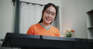 Low angle view shot, A determined young woman is practicing her keyboard alone and enjoys a peaceful moment with music. video