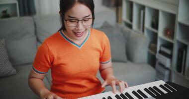 Determined young woman is practicing her keyboard alone and enjoys a peaceful moment with music. video