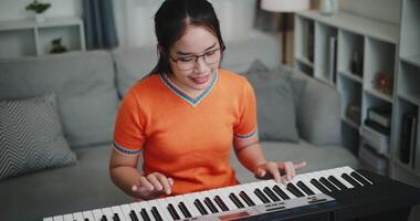 High angle view shot, Determined young woman is practicing her keyboard alone and enjoys a peaceful moment with music. video