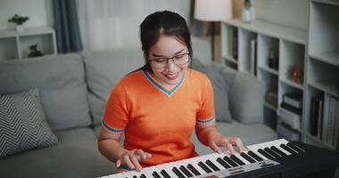 High angle view shot, A determined young woman is practicing her keyboard alone and enjoys a peaceful moment with music. video