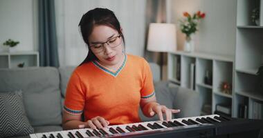 A determined young woman is practicing her keyboard alone and enjoys a peaceful moment with music. video