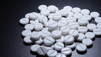 White medical pills rotating in a pile video