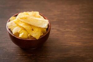 Banana Chips - fried or baked sliced banana in wooden bowl photo