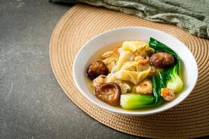 pork dumpling soup with shrimps and vegetable - Asian food style. photo