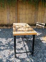 Rustic Wooden Table in Quaint Garden Cafe. photo
