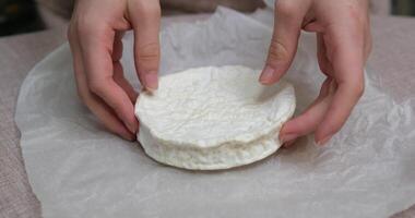 Cutting hard cheese into long pieces on a cutting board with a knife, in the kitchen. video