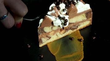Chocolate cake slice Chocolate shaving falling on a slice of fruit cake, slow motion at 500fps, rotating video
