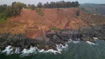 Waves hit ancient sea bastion near cliffs in Goa, India video