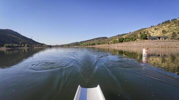 rowing on calm water of Horsetooth reservoir in Colorado - POV rower perspective photo