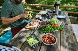 Outdoor Picnic Preparation on Rustic Table with Fresh Ingredients photo