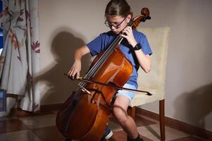 Young Musician Practicing Cello at Home in a Comfortable Setting Using Proper Technique photo
