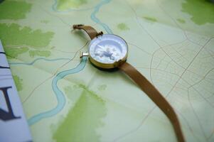 Gold-Bordered Compass on Map Depicting River and Forest Details for Travel and Navigation photo