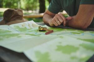 Exploring Nature With Map and Compass on a Wooden Table Outdoors photo
