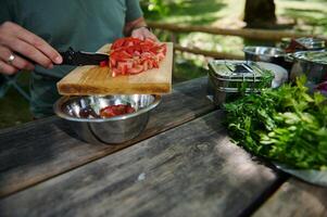 Outdoor Cooking Using Fresh Ingredients While Chopping Vegetables photo