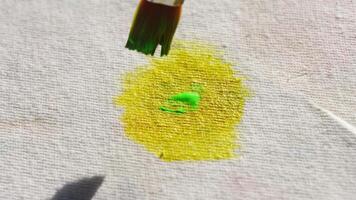 Brushstroke transition. vibrant yellow to green paint mixing on canvas in closeup art process. video