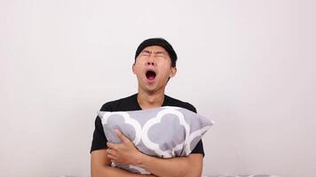 Man wake up and hugging pillow yawn and feel sleepy on white background video