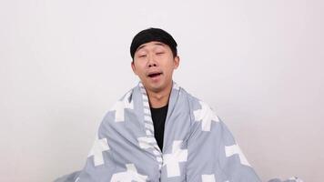 Asian man wake up and hugging pillow yawn and feel sleepy on white video