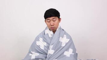 Asian man wake up and hugging pillow yawn and feel sleepy white isolated video
