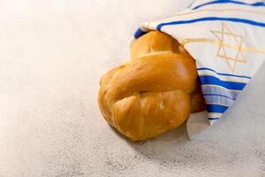 Challah bread covered with a cloth with a star of David. Shabbat Shalom. A traditional Jewish Sabbath ritual. photo