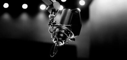 Professional studio, microphone with a pop filter is suspended boom arm and studio lights photo
