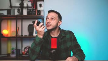 Man Speaking to AI Assistant on Smartphone While Holding It Near His Face at Home video