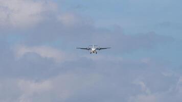 Front view of a commercial turboprop plane with unidentified livery approaching landing. Airplane in the sky. Travel concept video