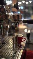 Espresso flows from coffee machine with blurred background video