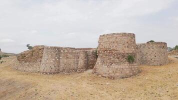 Aerial view ancient Rustavi Fortress ruins near lake surrounded by greenery and urban landscape in Georgia symbolizing history heritage and cultural tourism. video