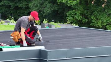 Roofing Contractor Working on a Flat EPDM Roof Installation in a Residential Area video