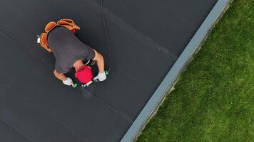 Roof EPDM Repair Work Being Done on a Residential Building in a Suburban Area video