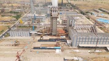 Aerial view Rustavi Azot factory complex in Georgia showing production buildings, storage tanks, tall chimneys emitting smoke, and extensive industrial infrastructure video
